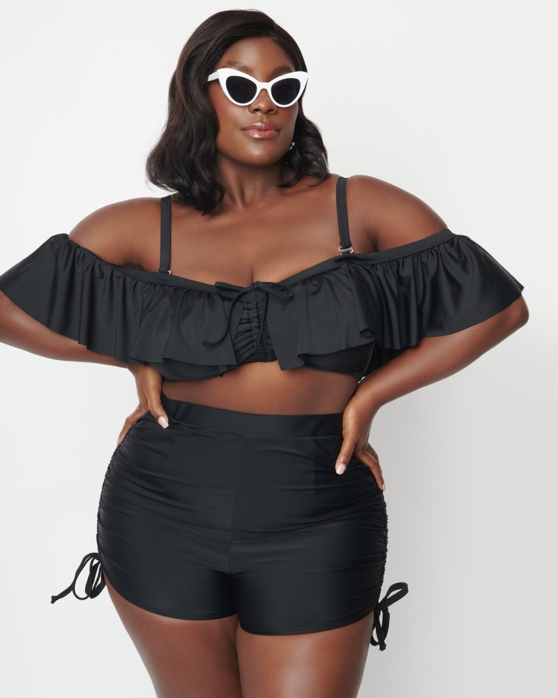 Front of a model wearing a size 4X Unique Vintage Black Pull Tie Swim Shorts in Black by Unique Vintage. | dia_product_style_image_id:288351